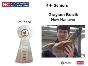 Grayson Brazik is pictured along side his chicken, a 3rd place ribbon is pictured along side him.