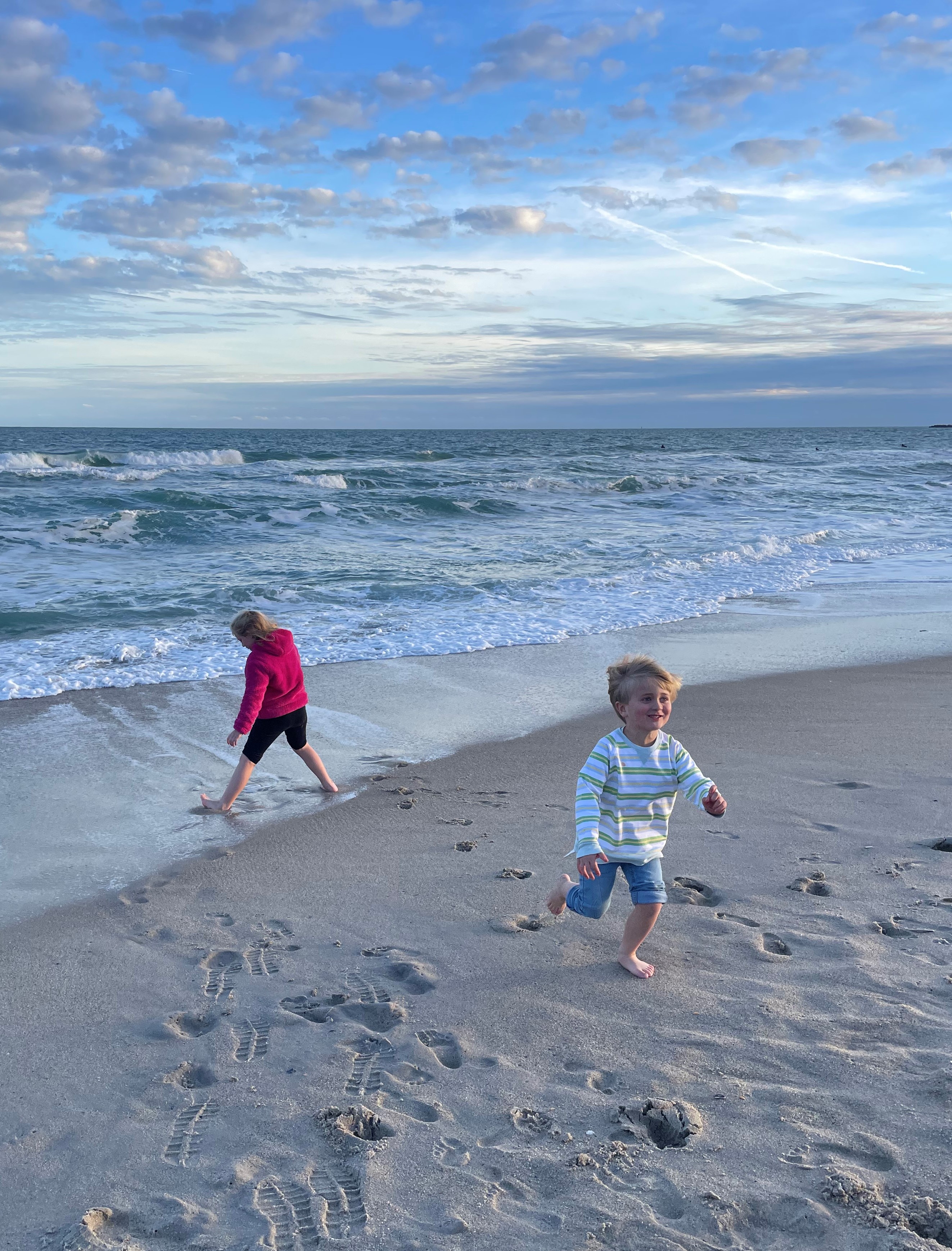 picture of children running happily at the beach
