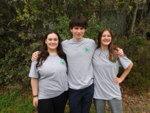 two youth females and one youth male posing