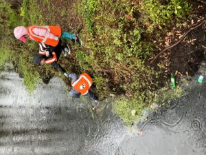 4-H members going down to the water's edge to collect a water sample