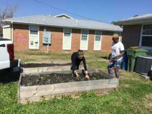 Sonya and Ability Garden intern planting in Creekwood