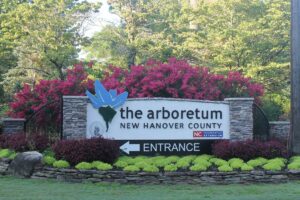 entrance sign to NHC Arboretum with flowers and plants 