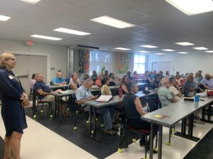 A group of adults in a classroom.