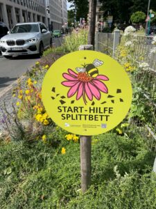 Sign in road median in Frankfurt, Germany saying "Save the Bees"