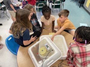 youth learning about an incubator