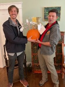 2 guys holding a pumpkin