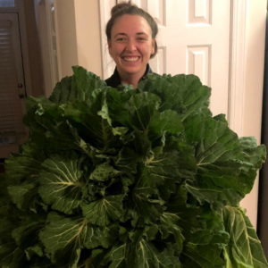 Morgan holding leafy greens that take up almost the whole image!