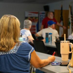 Participant taking notes during the volunteer led Fall Gardening Presentation
