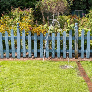 Sprinkler spraying water in a direct area, causing brown patch in turf